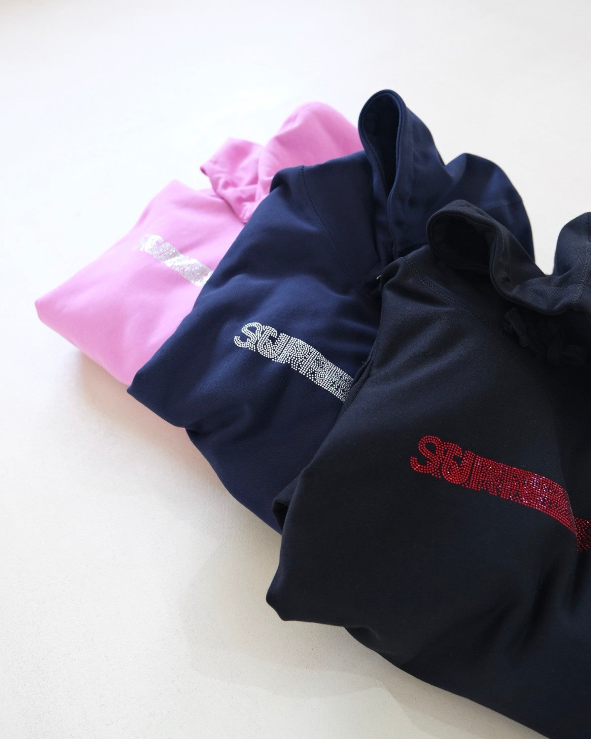 Supreme x Swarovski Men's and Women's FW25 WEEK4 Motion Logo Hooded Sweatshirt rhinestone dynamic logo kangaroo pocket hooded sweatshirt #332326